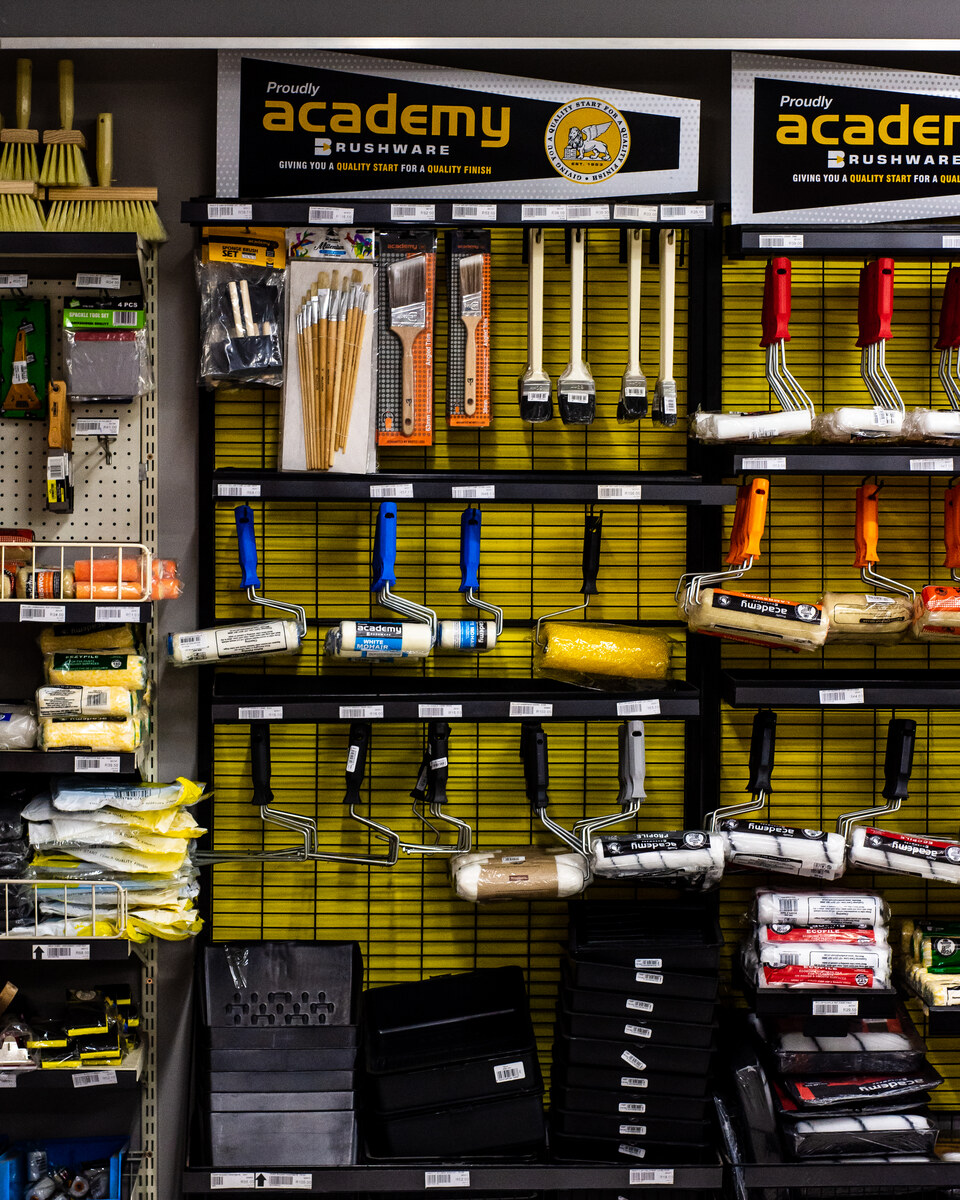 Academy paint brushes and rollers on a display wall