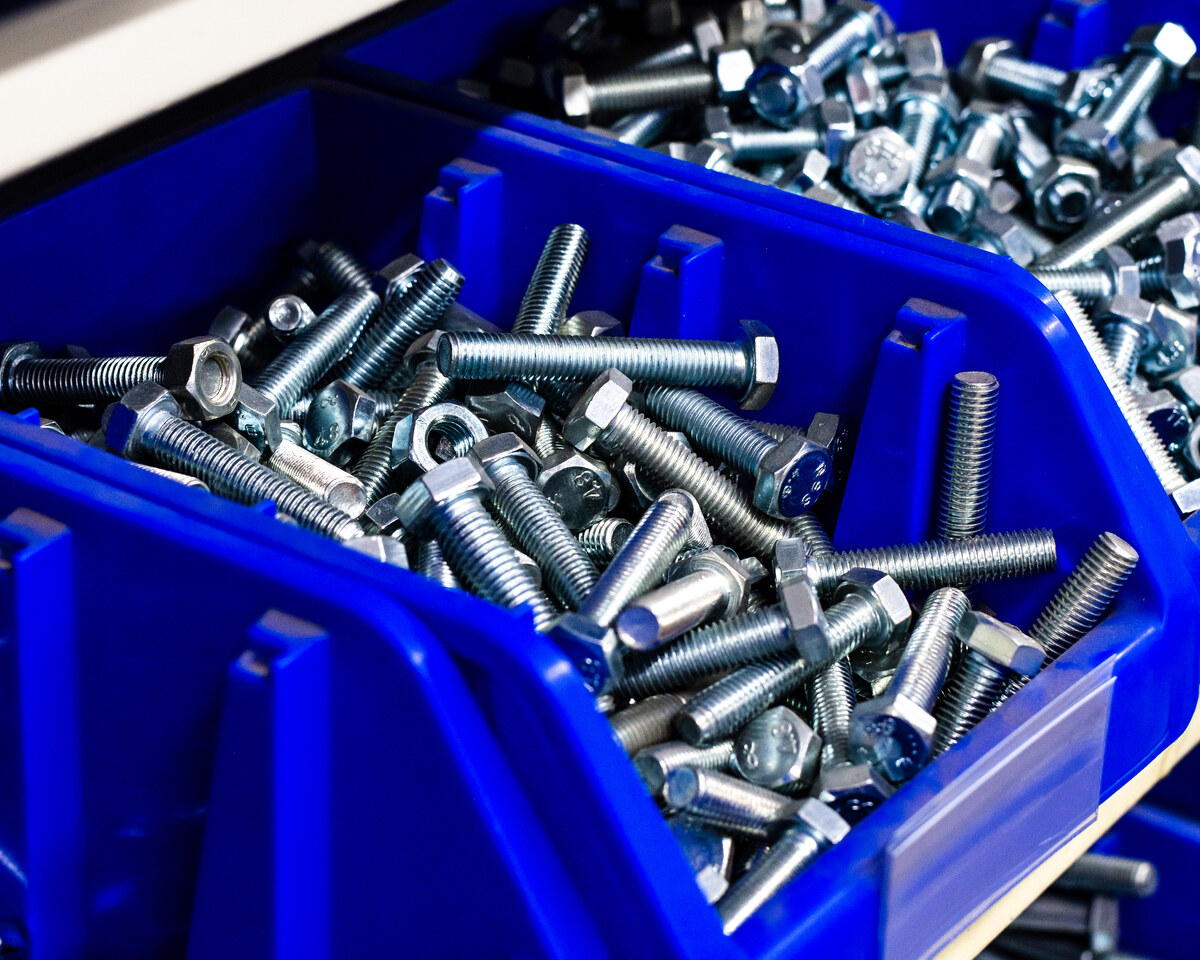 Bolts and nuts in blue storage bins