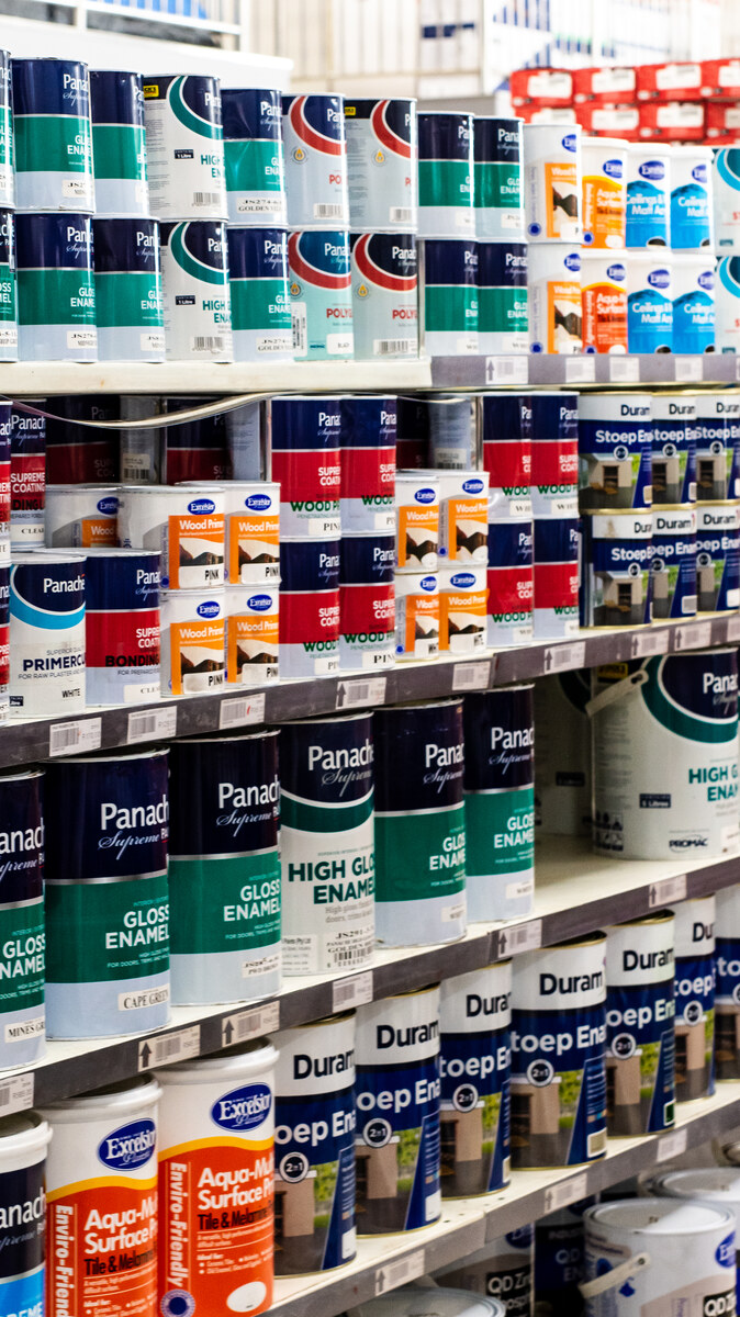 Shelves stacked with paint tins