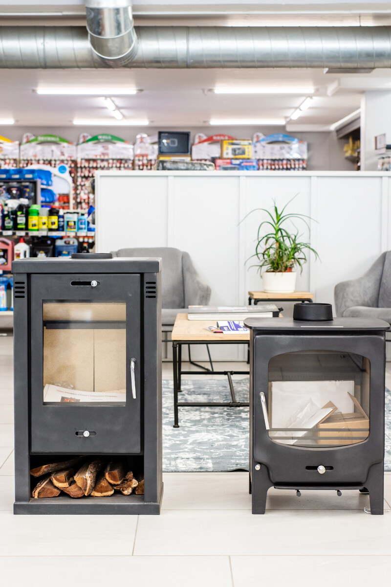 Two cast-iron wood-burning fireplaces on display in the showroom