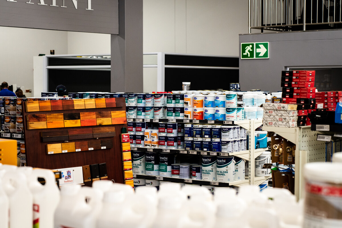 Paint aisle with colourful paint tins and shelving