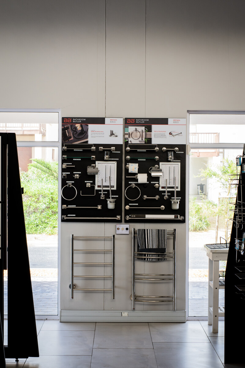 Towel rails and bathroom accessories displayed by the entrance