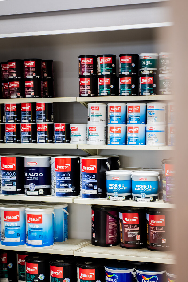 Plascon paint tins stacked on shelves