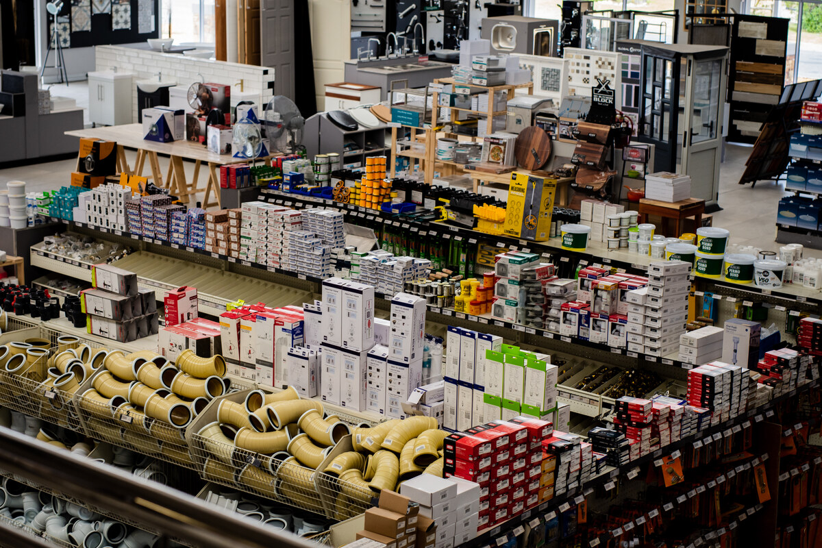 Plumbing fittings and pipe bends on display shelves